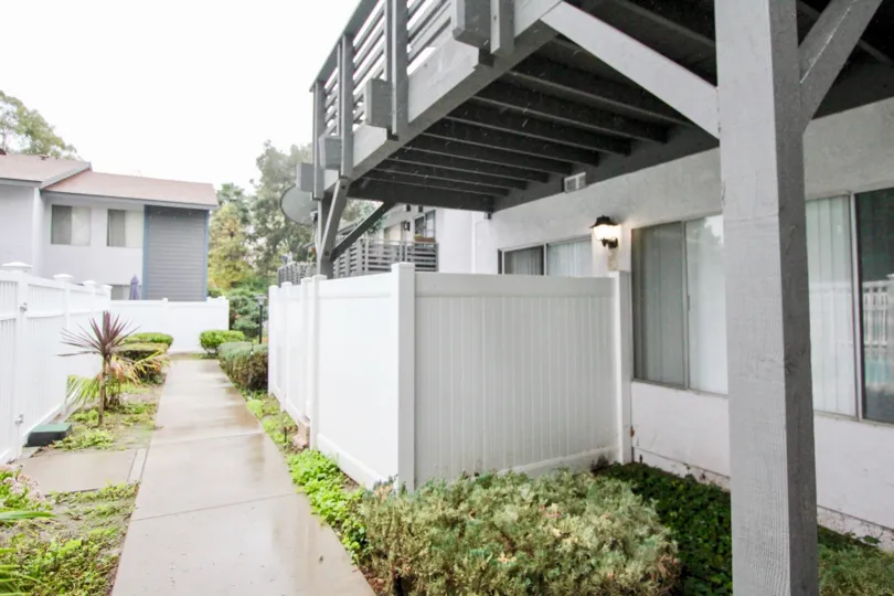 THE SIDE VIEW OF HOME LOCATED IN LA HABRA, THAT HAVE THE PATHWAY ON EACH SIDE SMALL PLANTS ARE THERE
