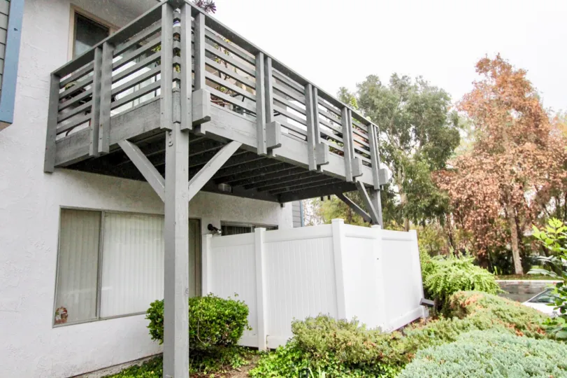 A balcony in the Woodlake Village with some trees around.