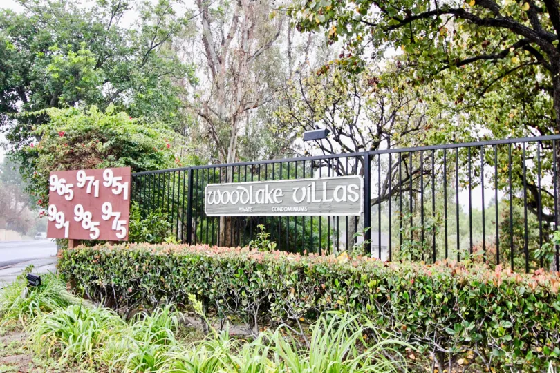 Greenish park near villas having name plate in Woodlake Villas of La Habra