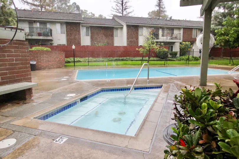 A pool in Woodlake Villas with some plants and light.