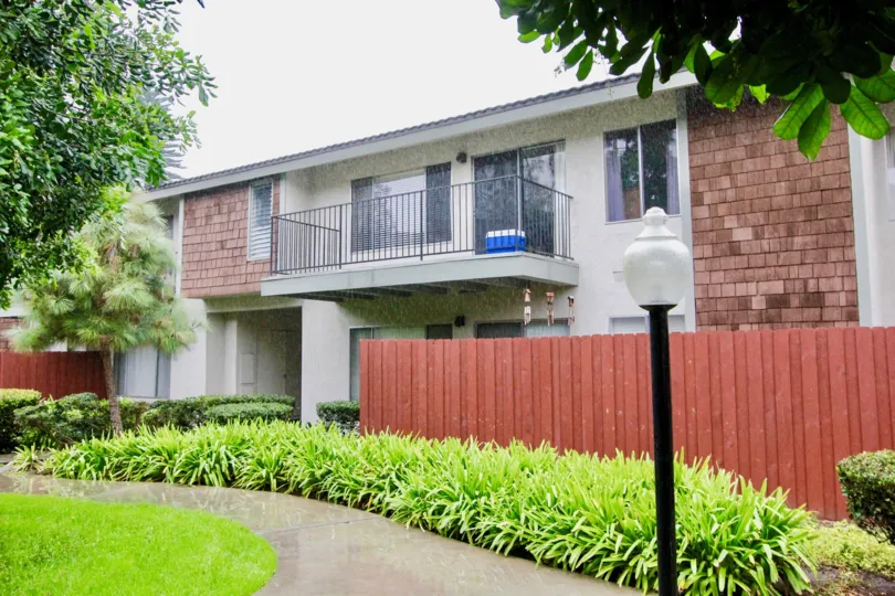 a pleasant day in the woodlake villas with a building that has lamp post in front and garden around