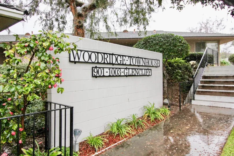 The Woodridge Townhouse with flowering plants and steps in the front side