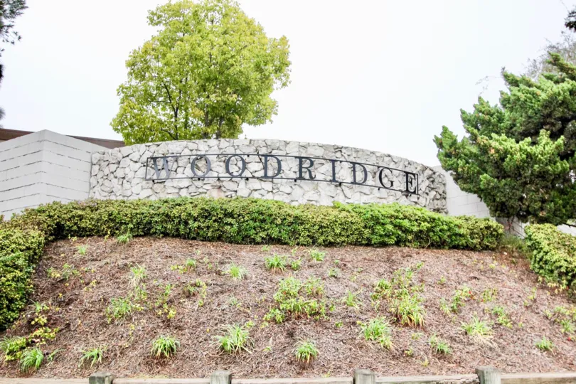 A day in the Woodridge Townhouse with a sign and plants.