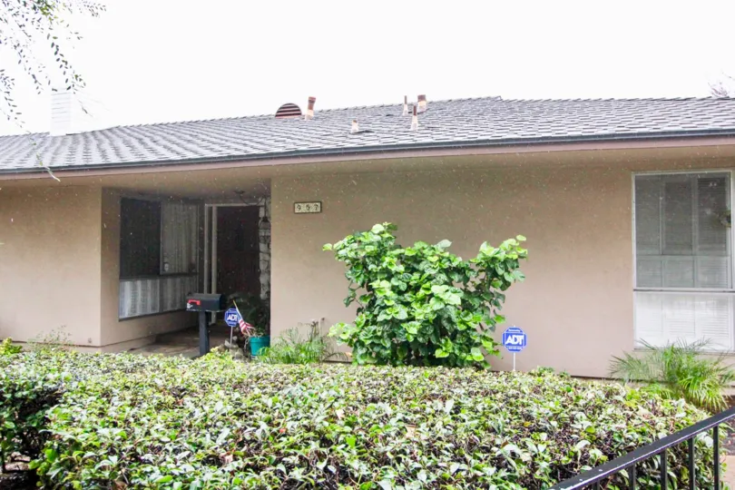 Rain is falling at the Woodridge Townhouse with postal box and plants