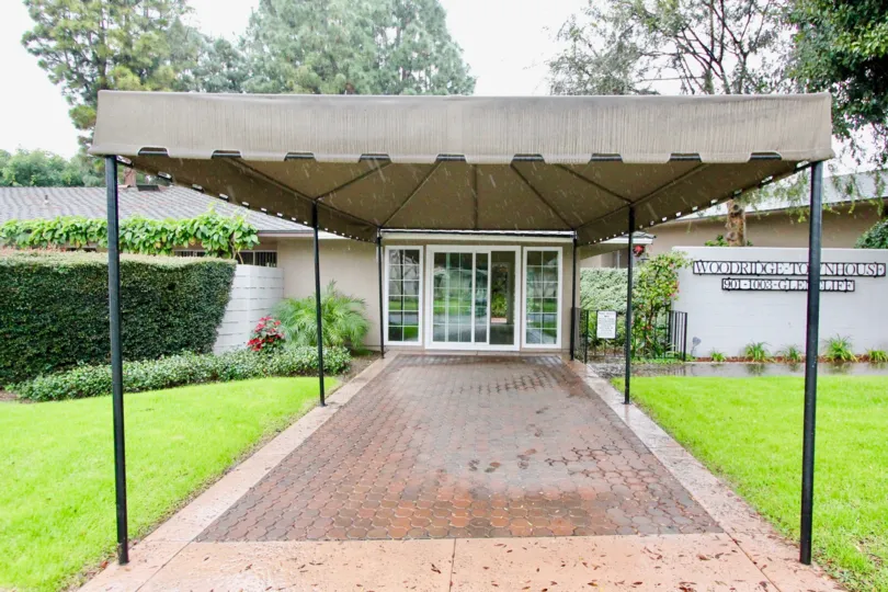 An entrance door in the Woodridge Townhouse with a beautiful lawn.