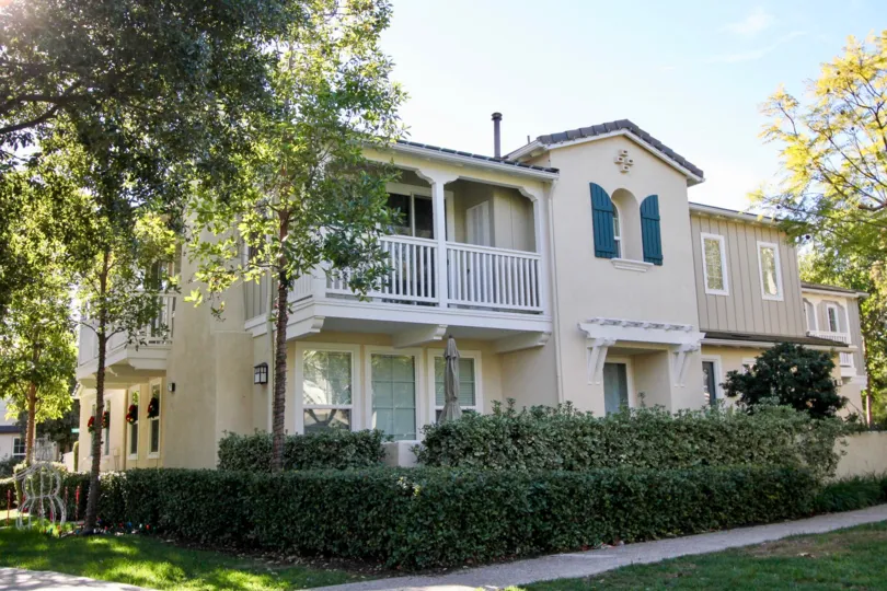 Decorative teal shutters sit near a window on a building in the Atherton Glen homes