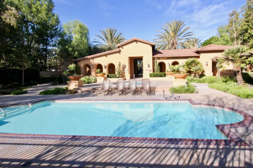 the house with swimming pool and some chairs