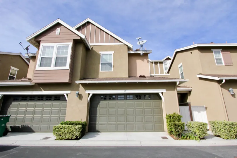 A sunny day in the area of Branches, outside, garages, satelite dish, door, bushes