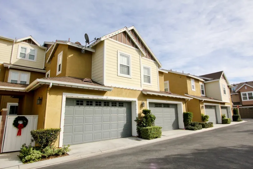 A sunny day in the area of Branches, outside, garages, satelite dish, wreath, door, bushes