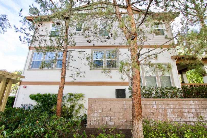 A sunny day in the area of Briar Rose, outside, condo, trees, porch, fence, windows