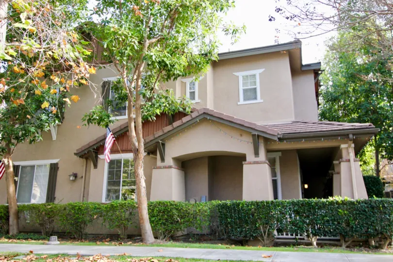 This is an image of a house which also has a garden. The garden has trees surrounding it.