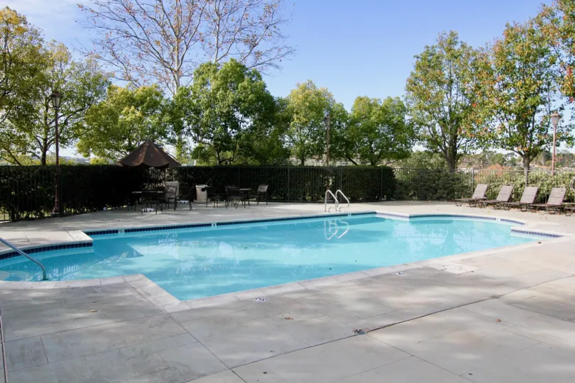 A blue color swimming pool under the clear sky in the Chambray.