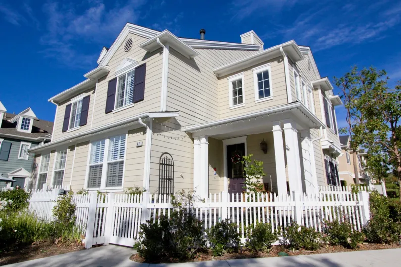 Corner view of the white picket fence and quaint residence at Charleston Place in Ladera Ranch, California