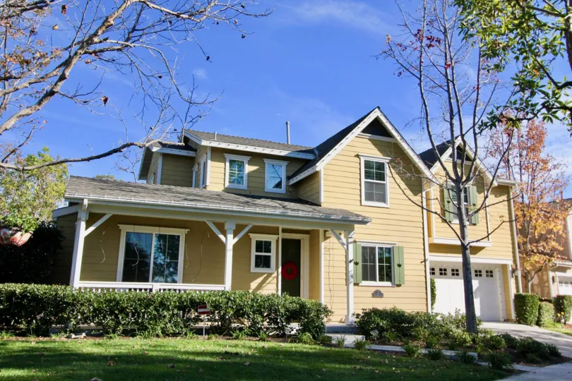 A beautiful cottage with the contrast of cream & grey colured with free space & some greenery