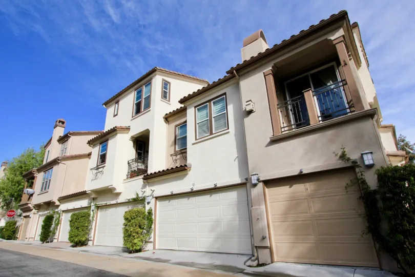 A tan homes with garages in Sansovino community in Ladera Ranch, California.