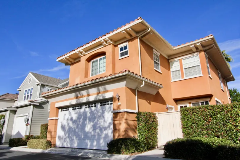 two story house with big garage and shrubbery in st marys road community in ladera ranch california