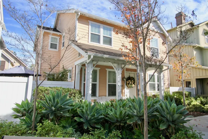 A SIGHT OF BEAUTIFUL HOUSE WITH THE CONTRAST OF PEACH & WHITE COLOR WITH SOME GREEN AREA