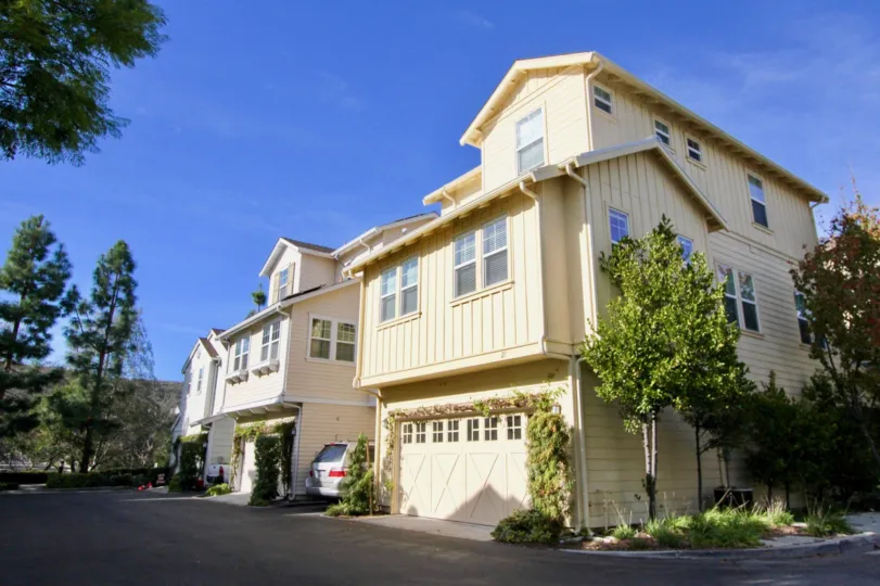 A sunny day in the area of Sutters Mill, outside, condos, trees, garage, windows, roof, sky