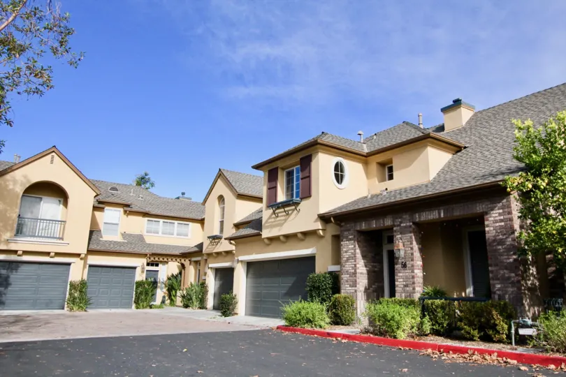 Homes with garages and stone pillars in Sycamore Grove community in Ladera Ranch, California.