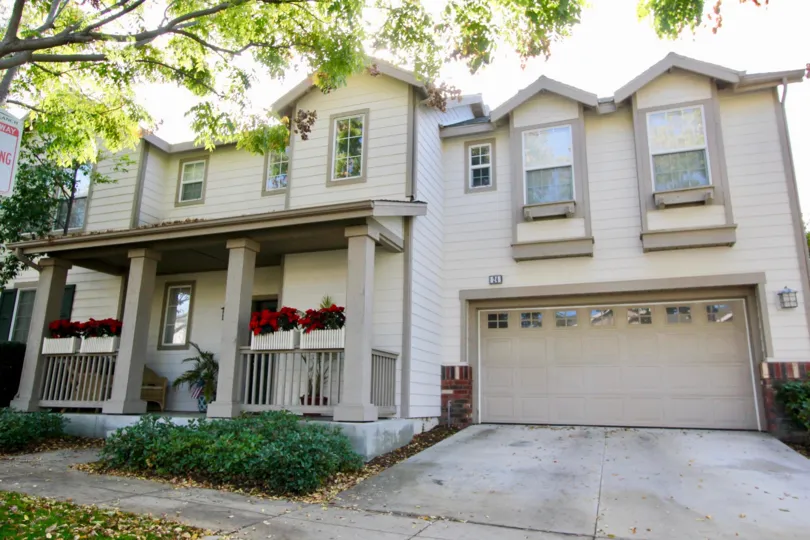 This image represents the front view of the beautiful house with shed which have the lot of plants with flowers and the pathway to the home in the city of Ladera Ranch
