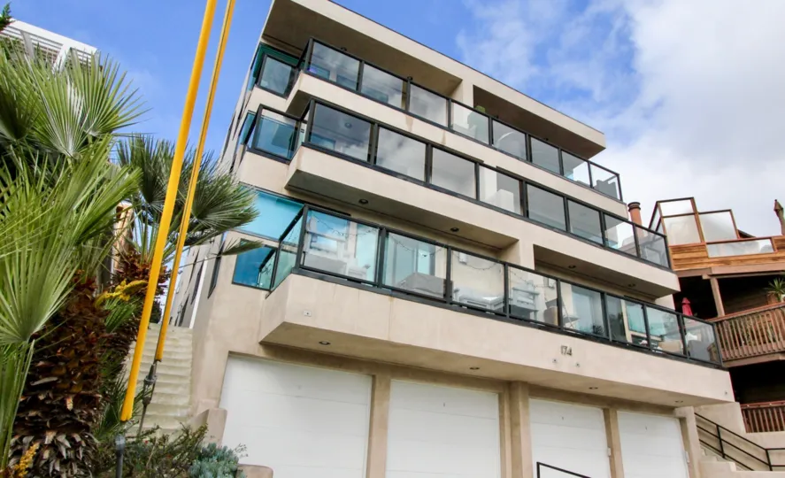 a warm day in the 174 cliff drive with building that has glass of front in the trees