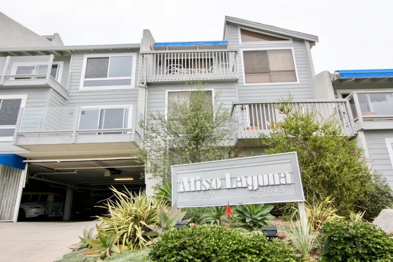 A sign that reads Aliso Laguna outside of a three story complex in Laguna Beach CA