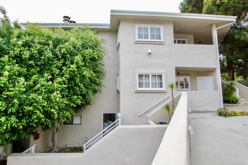 Two story Building with windows and a tree in the Creekside Community in Laguna Beach, CA.
