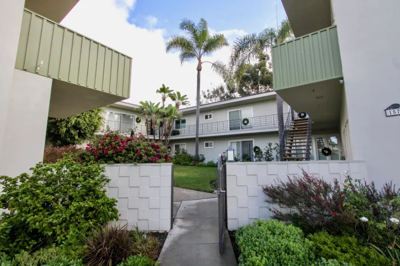 THE 157TH APARTMENT IN THE CROWN POINT WITH THE STEPS, FLOWER PLANTS, TREES