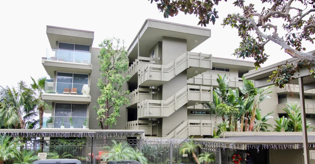 a pleasant day in the laguna lido with a building that has three storeys and has glass wall too