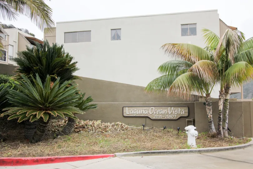 THE 21731-21807 APARTMENT IN THE LAGUNA OCEAN VISTA WITH THE TREES, PLANTS, NAME BOARD