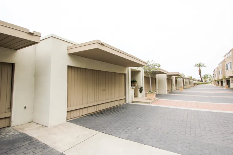 A sunny day in the Laguna Ocean Vista with a path between apartments.