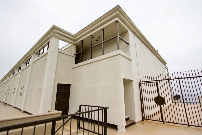 A cloudy day in the Laguna Royale with a modern building and gate.