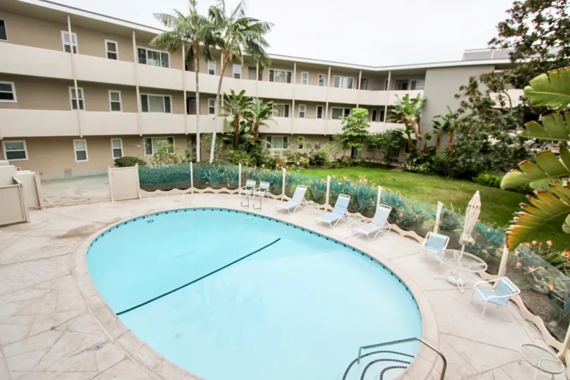 Apartment building with trees and a pool in the Table Rock Community in Laguna Beach, CA.