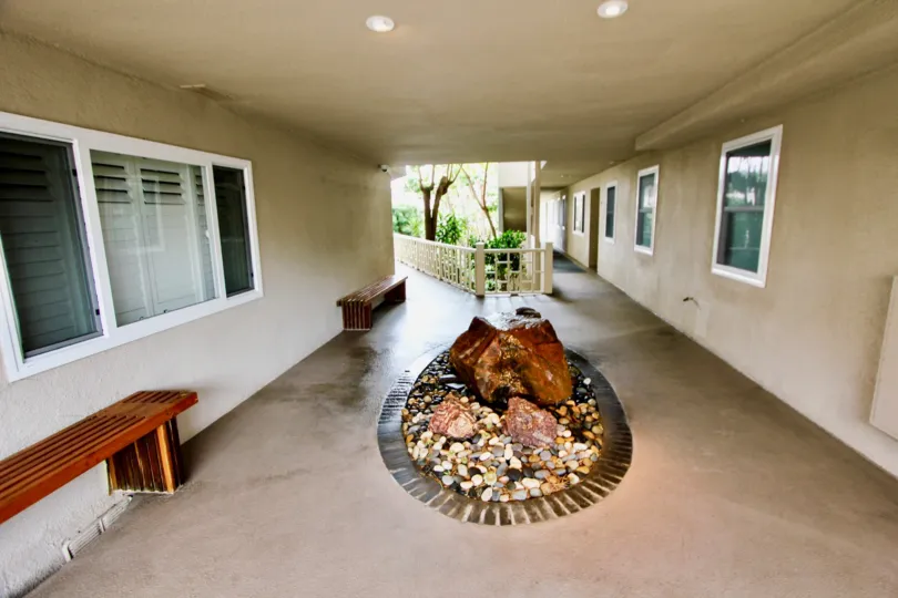 THE HOUSE IN THE TABLE ROCK WITH THE ROCKS, STONES, STONE BENCH, GLASS WINDOW, PLANTS, TREES