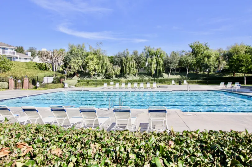 THE HOUSE IN THE BEACON HILL VISTAS WITH THE SWIMMING POOL, CHAIRS, PLANTS, TREES