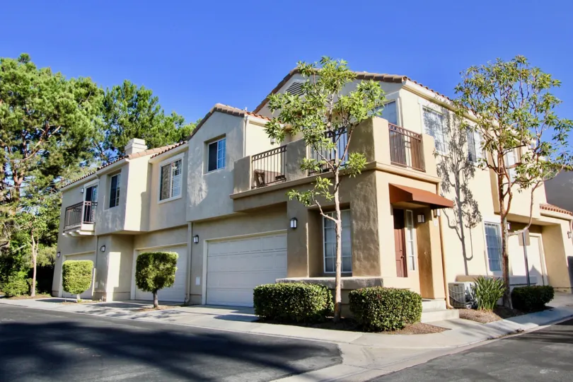 A tan building with three garages in Chandon community in Laguna Niguel, California.