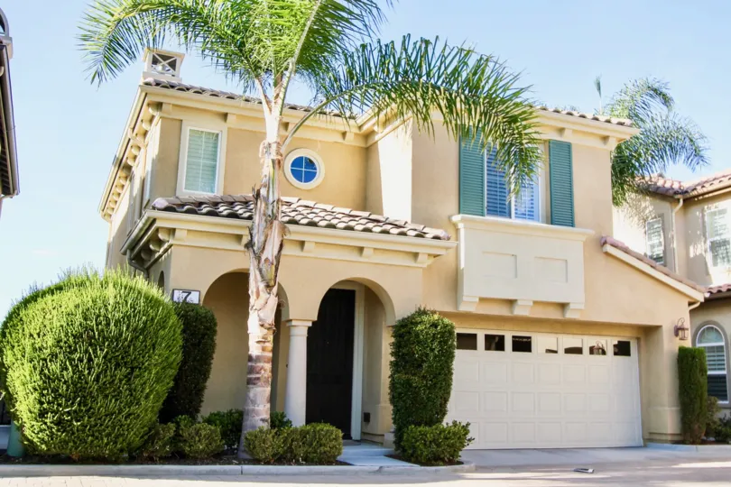 A nice house is in the Cornerstone with a palm tree.