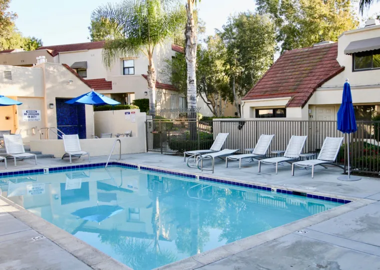 THE HOME IN THE CRYSTAL CAY WITH THE UMBRELLA, SWIMMING POOL, CHAIRS, PLANTS, TREES