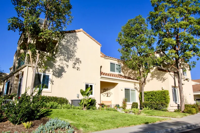 A sunny day in the area of Encore, outside, blue sky, trees, condo, bushes, balcony