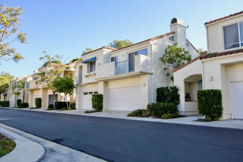 Street view of the Encore Community in Laguna Niguel, California. Two car garage residences with front balconies.