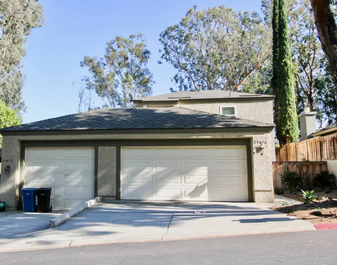 Two dustbins for lamp and tall pine trees in Foothill Townhomes.