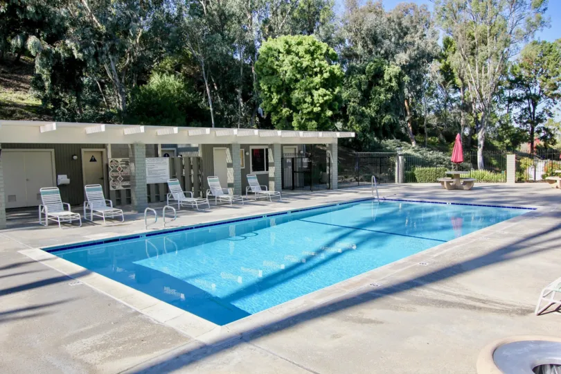 Beautiful Swimming Pool with trees and sitting in Foothill Townhomes of Laguna Niguel