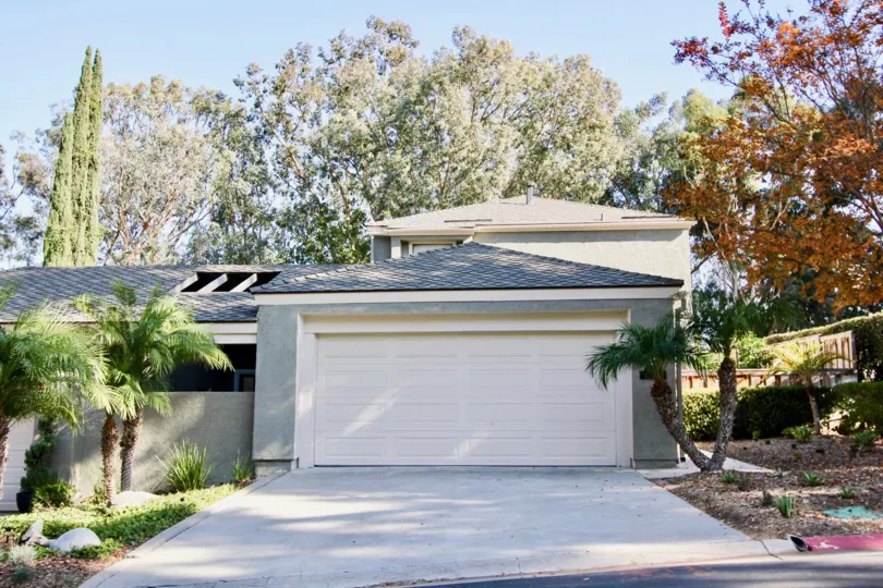 A white color car porch door in front of a building in the Foothill Townhomes.