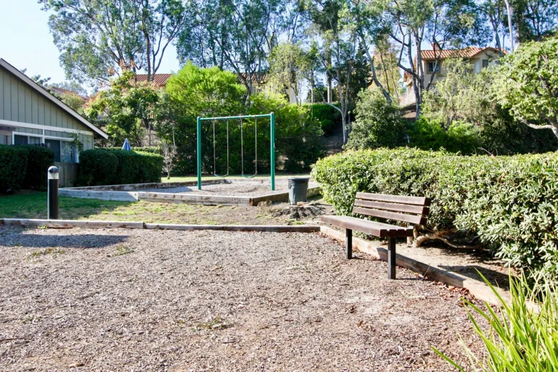 THE HOUSE IN THE FOOTHILL TOWNHOMES WITH THE STONEBENCH, SWING, PLANTS, TREES
