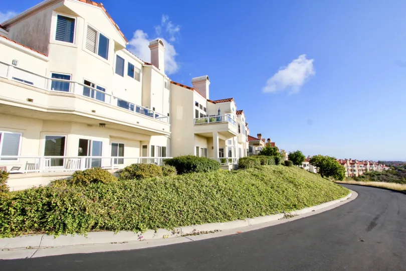 Villas with lawn and roadside on sunny day in Laguna Sur of Laguna Niguel