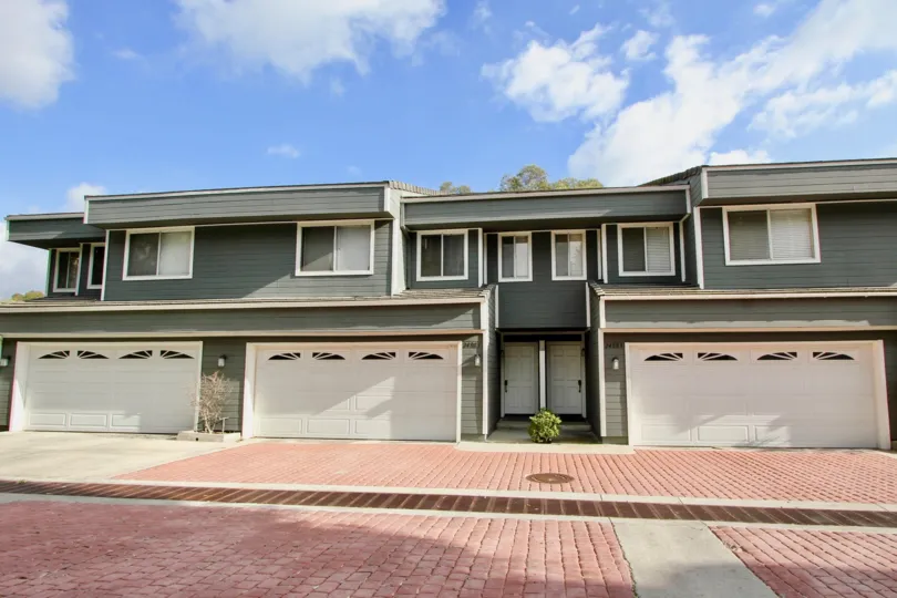 A SIGHT OF BEAUTIFUL APARTMENT WITH THE CONTRAST OF GREY & WHITE COLOR LOCATED ON THE ROAD SIDE