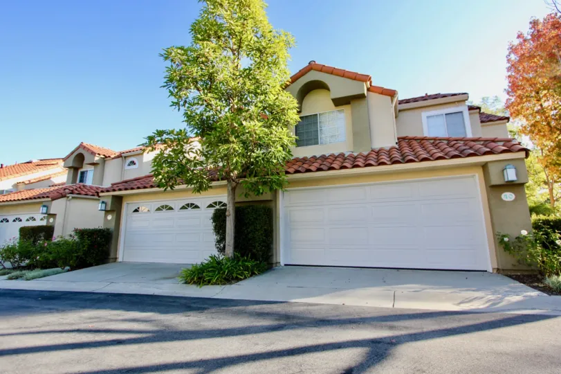 Two white garage doors sit on front of a townhome at Niguel Vista homes