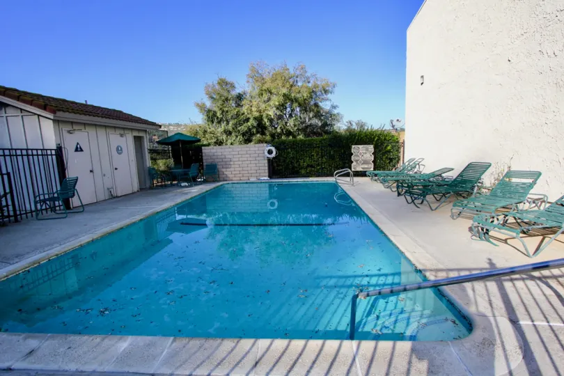 a warm day in the rancho niguel with a building that has clear blue swiming pool in it
