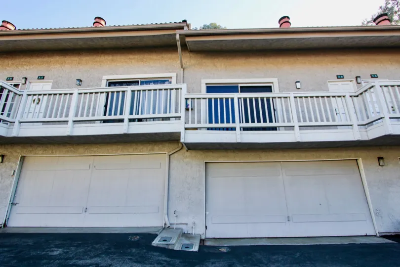 A sunny day in the area of Rancho Niguel, outside, condos, balcony, railing, chimney, doors, garages