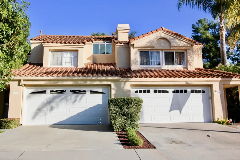 Bright sunny day in front of a villa with trees around in Saltaire of Laguna Niguel